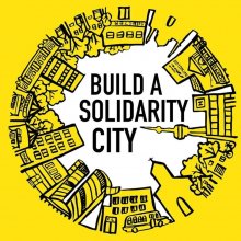 Stadtsilouette in einem Kreis. Schrift: Build a Solidarity City